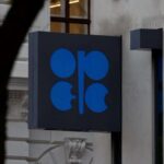 Placa com logotipo da Opep em edifício, representando a organização e sua influência no mercado global de petróleo.