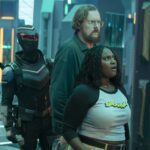 Vigilante, Economos and Adebayo stand in the extradimensional room on Peacemaker Season 2 Episode 6,