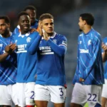 Max Aarons applauds the Rangers fans at the end of a game