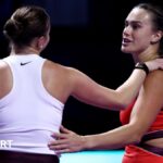 Aryna Sabalenka and Amanda Anisimova embrace at the net after their match