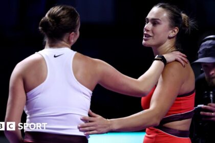 Aryna Sabalenka and Amanda Anisimova embrace at the net after their match