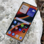 The Samsung Galaxy S25 Ultra laying outside with its display on.