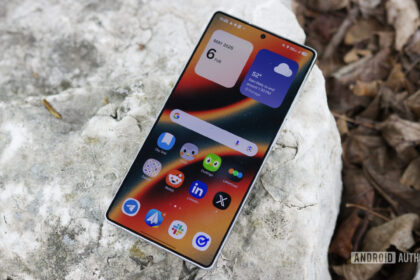 The Samsung Galaxy S25 Ultra laying outside with its display on.