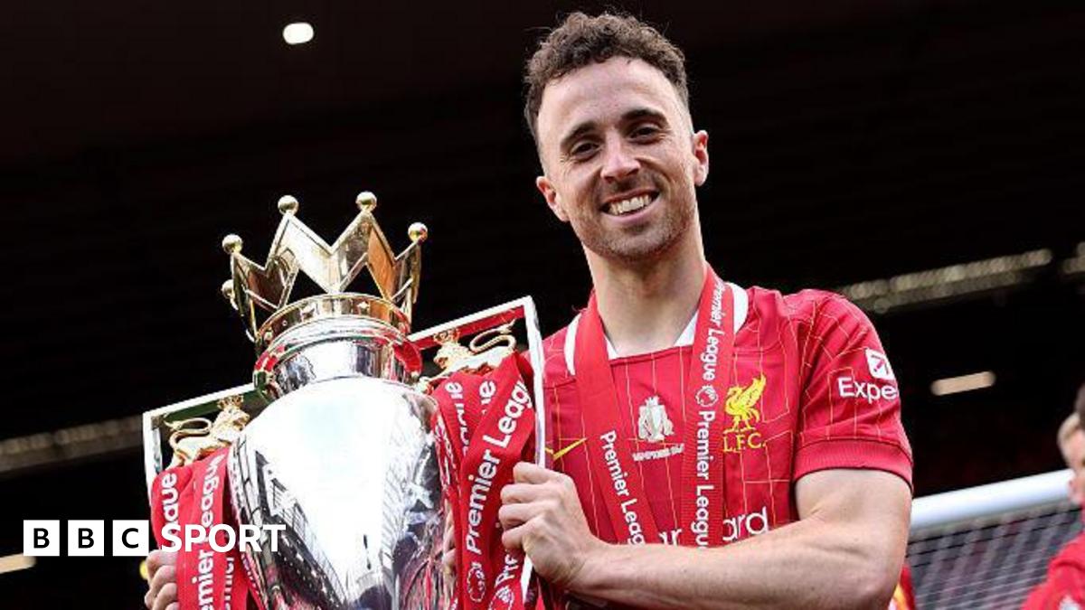 Diogo Jota holding the Premier League trophy while playing for Liverpool in May