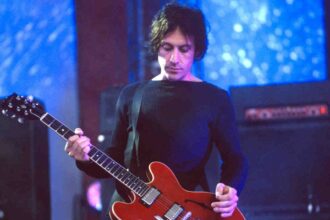 The Cure’s Perry Bamonte performing onstage in 2000