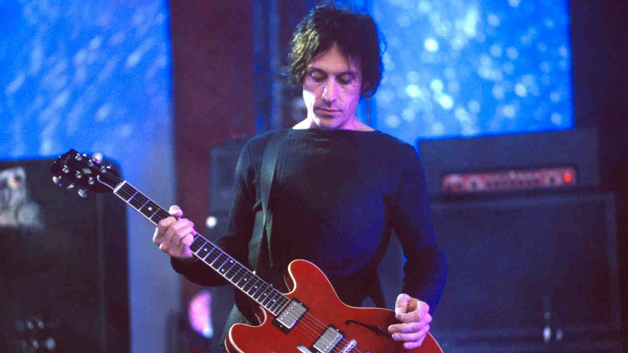 The Cure’s Perry Bamonte performing onstage in 2000